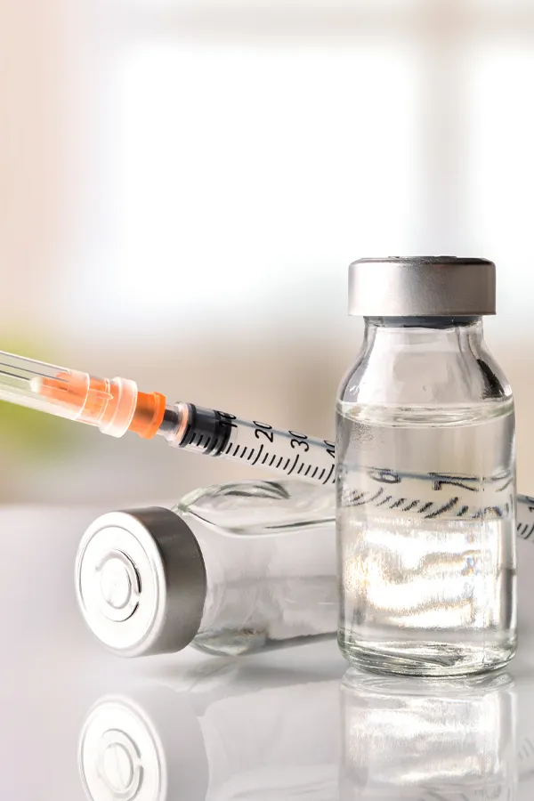 A close up of two vials of Juvederm filler and a syringe, on a counter in a home in Miami.