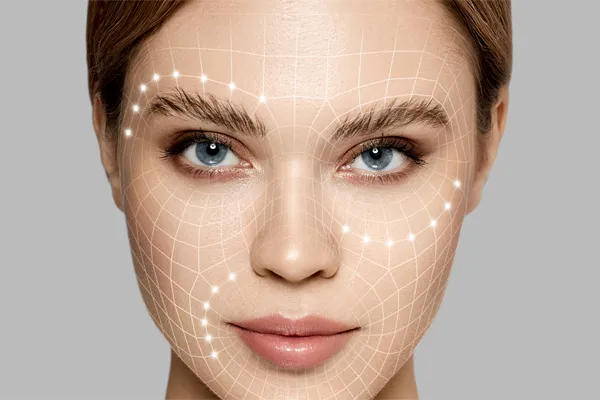 A close up of a beautiful woman's face with an illustrated contoured grid overlaying it, signifying aesthetic filler treatments from Vida Integrative Health of Miami in Miami.