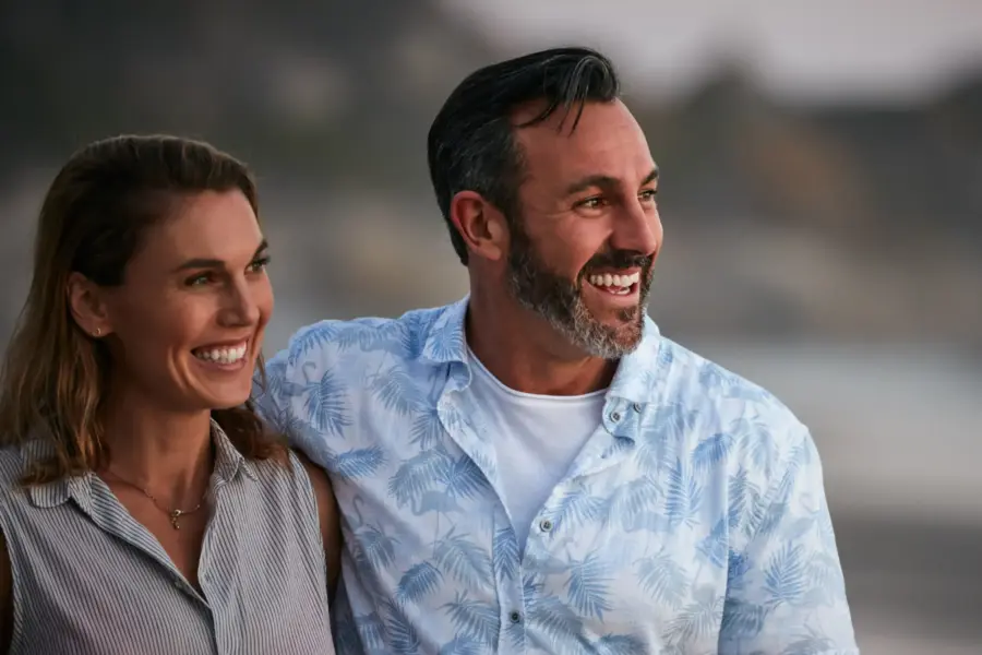 A man and woman enjoy a walk on the beach, invigorated from bioidentical hormone therapy treatments from Vida Integrative Health of Miami in Miami.