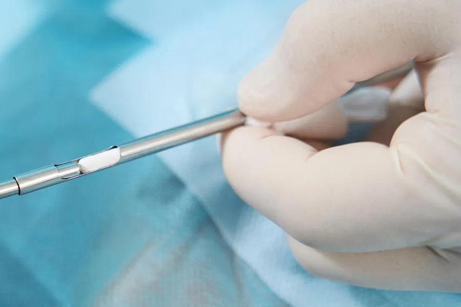 Close up of a doctor inserting a hormone pellet into a delivery device for hormone pellet treatments from Vida Integrative Health of Miami in Miami.